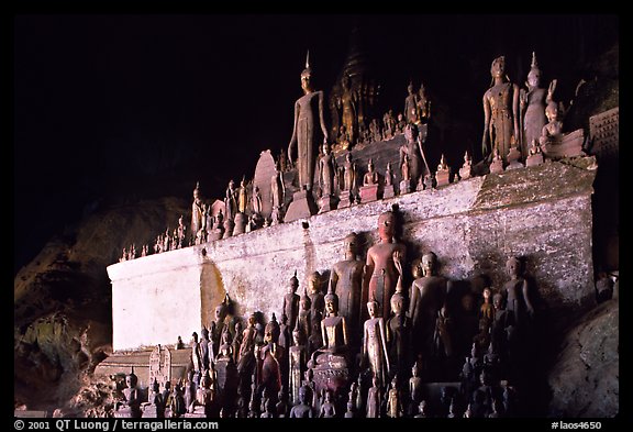Buddha statues left by pilgrims in Pak Ou caves. Laos (color)