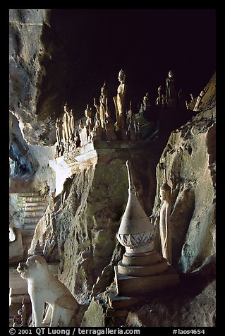 Buddhist statues left by pilgrims, lower Pak Ou cave. Laos (color)