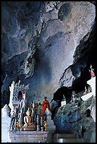 Novice Buddhist monk in  Tham Ting cave,  Pak Ou. Laos (color)