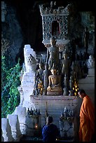 Novice Buddhist monk and vistor in Pak Ou cave. Laos