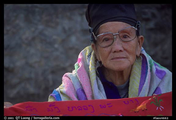 Older woman wears a mix of tribal and western garb. Luang Prabang, Laos