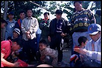 Coaches take care of wounded roosters after fighting. Luang Prabang, Laos (color)