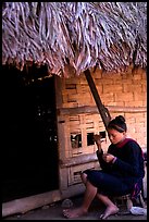 Woman of the Lao Huay tribe in front of her hut,  Ban Nam Sang village. Laos