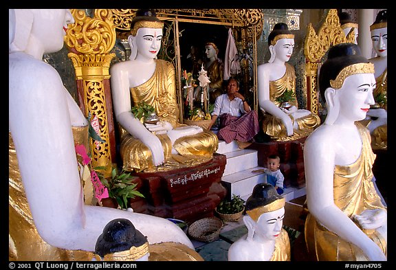 Surrounded by Buddha statues, Shwedagon Paya. Yangon, Myanmar