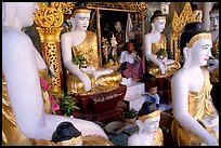 Surrounded by Buddha statues, Shwedagon Paya. Yangon, Myanmar