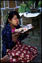 Burmese woman offering food. Bagan, Myanmar