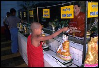 Novice offering Water at  Mahamuni Paya. Mandalay, Myanmar