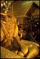 Adding golden leaves to the venerated Mahamuni image. Mandalay, Myanmar ( color)