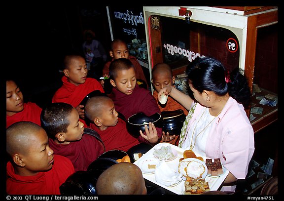 Novice during alm round at Mahamuni Paya. Mandalay, Myanmar (color)