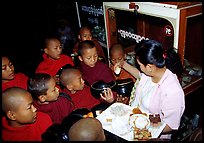 Novice during alm round at Mahamuni Paya. Mandalay, Myanmar