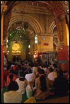 Woman praying at the venerated Mahamuni image. Mandalay, Myanmar