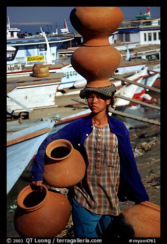 Carrying many jars. Mandalay, Myanmar (color)
