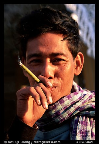 Man enjoying a cheerot (burmese cigar). Mandalay, Myanmar (color)