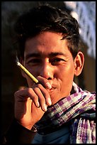 Man enjoying a cheerot (burmese cigar). Myanmar