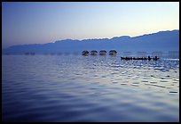 Long boat,  stilts huts, and mountains, sunrise. Inle Lake, Myanmar (color)