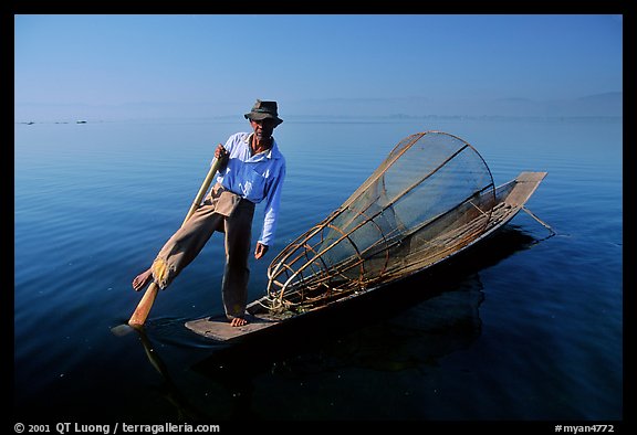 Intha fisherman on duggout with net. Inle Lake, Myanmar (color)