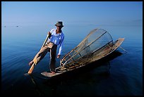 Intha fisherman on duggout with net. Inle Lake, Myanmar