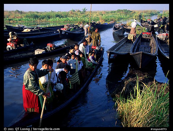 Children commuting to school on small boat. Inle Lake, Myanmar (color)