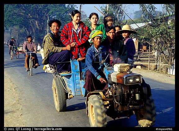 Riding tractor on road near Swwenyaung. Shan state, Myanmar (color)