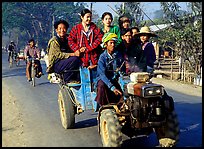 Riding tractor on road near Swwenyaung. Shan state, Myanmar (color)