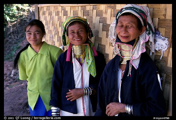 Three generations of Padaung women	along hut. Shan state, Myanmar (color)