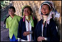 Three generations of Padaung women	along hut. Shan state, Myanmar