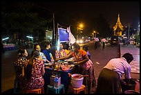 Streat food served at night, Shwedagon Pagoda in background. Yangon, Myanmar