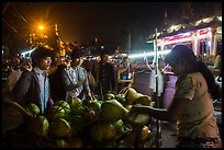 Customers waiting for coconuts to be cut on the street. Yangon, Myanmar ( color)
