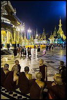 Monks, Terrace and Naungdawgyi (Elder Brother) Pagoda at night, Shwedagon Pagoda. Yangon, Myanmar ( color)
