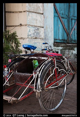 Sai kaa rickshaw and old facade. Yangon, Myanmar (color)