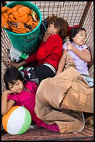 Children sleeping in street cleaning cart. Yangon, Myanmar ( color)