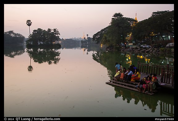 Families on shore of Kandawkyi Lake at sunset. Yangon, Myanmar (color)