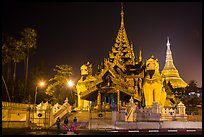 Southern gate guarded by two leogryphs and Main Stupa at night, Shwedagon Pagoda. Yangon, Myanmar ( color)