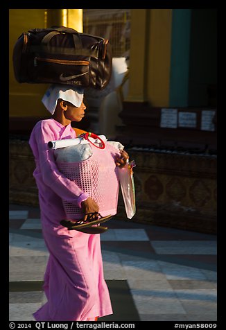 Nun carrying lots of luggage, Shwedagon Pagoda. Yangon, Myanmar (color)