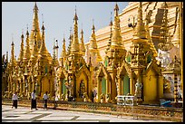 Men walking near stupas, Shwedagon Pagoda. Yangon, Myanmar ( color)