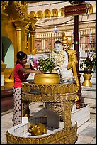 Woman worshipping at planetary post. Yangon, Myanmar ( color)