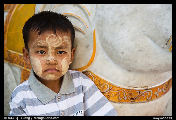 Child with thanaka paste next to elephant. Yangon, Myanmar (color)