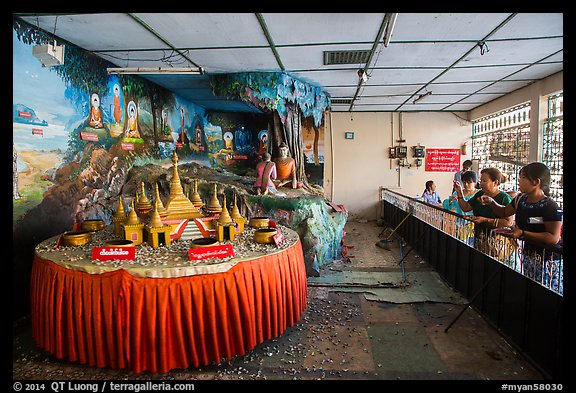 Visitors play arcade game, Botataung Pagoda. Yangon, Myanmar (color)