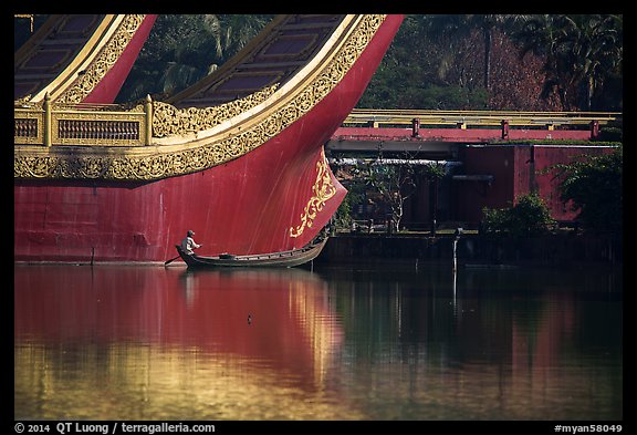 Man rowing boat next to Karawek barge. Yangon, Myanmar (color)