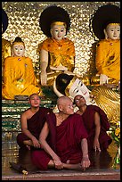 Monks and buddha statues, Shwedagon Pagoda. Yangon, Myanmar