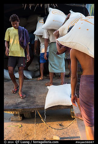Workers load bags of rice into truck, Sinodan pier. Yangon, Myanmar (color)