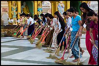 Women lining up to sweep the platform, Shwedagon Pagoda. Yangon, Myanmar