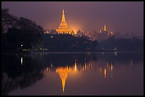 Shwedagon Pagoda reflected in Royal (Kandawgyi) Lake at twilight. Yangon, Myanmar