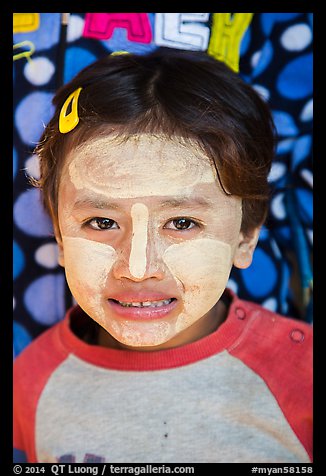 Infant with face covered in thanaka paste. Bagan, Myanmar (color)