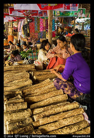Women selling wood ground to make thanaka. Bagan, Myanmar (color)