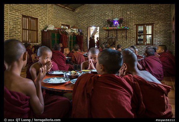 Buddhist novices pray at table before eating lunch, Nyaung U. Bagan, Myanmar (color)