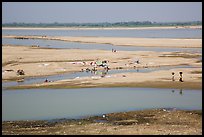 Sandy banks of Ayeyarwaddy River with villagers washing clothes. Bagan, Myanmar ( color)