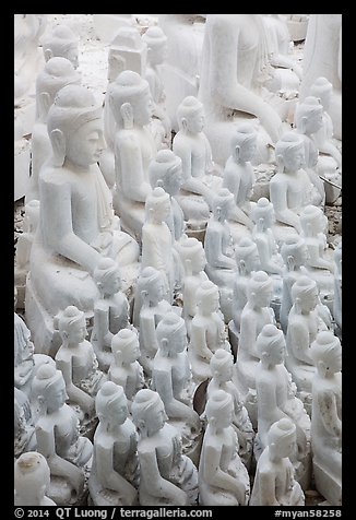 Unfinished white marble buddha statues of various sizes. Mandalay, Myanmar (color)