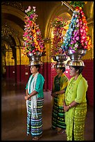 Women carry elaborate flower offerings on their head, Mahamuni Pagoda. Mandalay, Myanmar ( color)