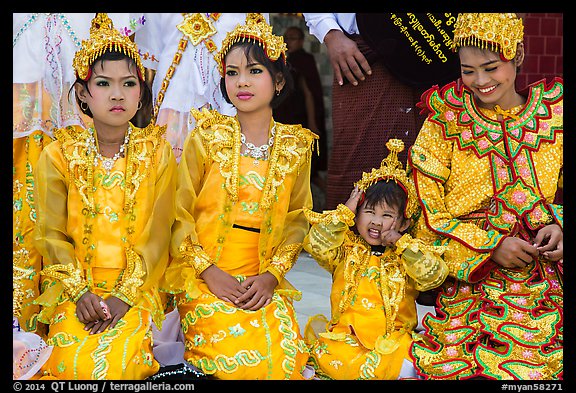 Girls with make-up and princely attire reacting during Noviciation, Mahamuni Pagoda. Mandalay, Myanmar (color)